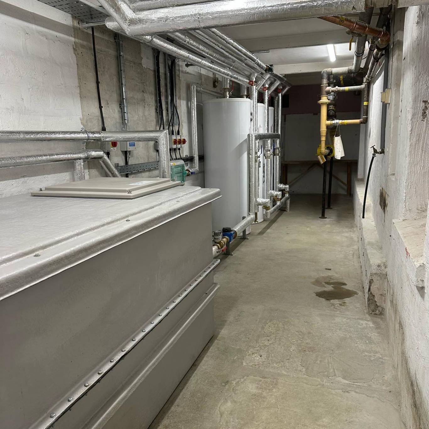 Plant room corridor with storage tanks, cylinders and a gas train