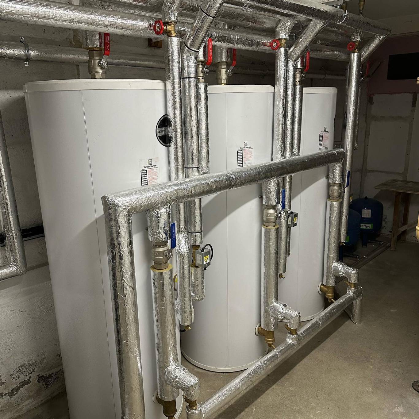 Three Telford Tempest calorifiers installed in a row in a plant room