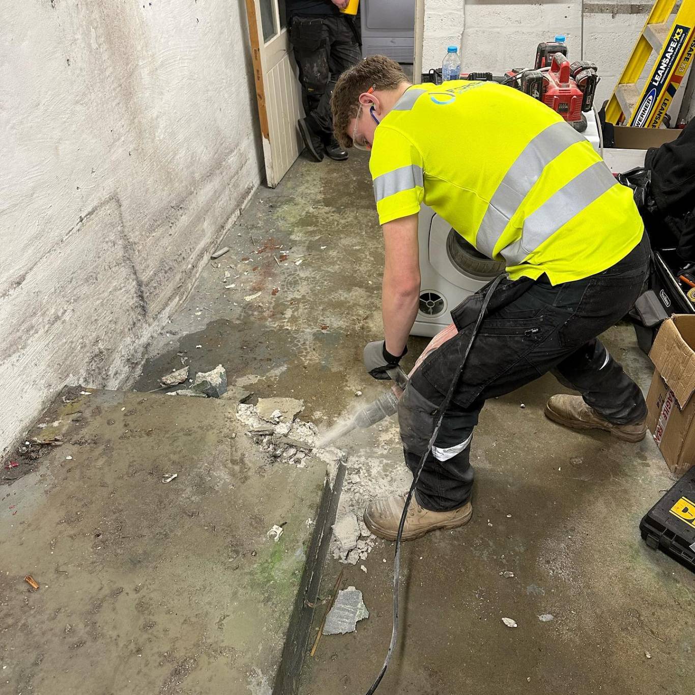 Forshaw engineer breaking out a floor slab to run new drainage