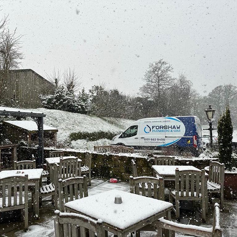 Forshaw Sprinter van on site in the snow, livery reading Domestic, Commercial, Industrial