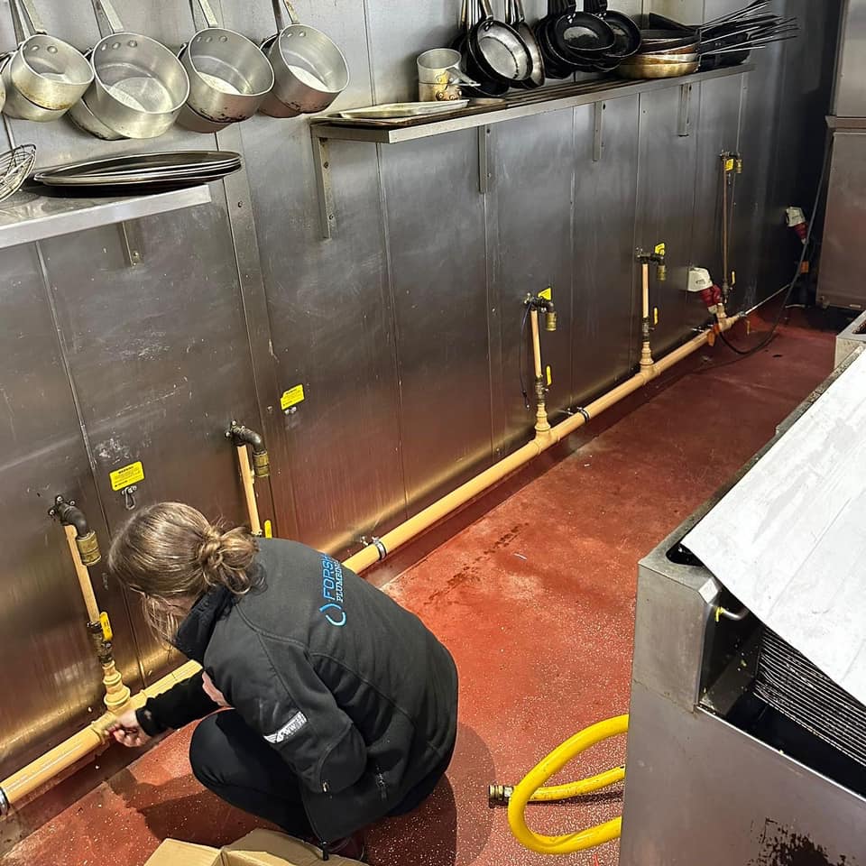 Forshaw engineer installing gas pipework to a commercial catering kitchen