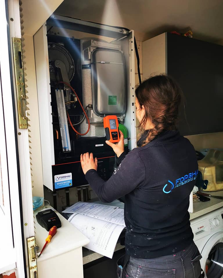 Forshaw engineer carrying out a flue gas analysis on a domestic boiler